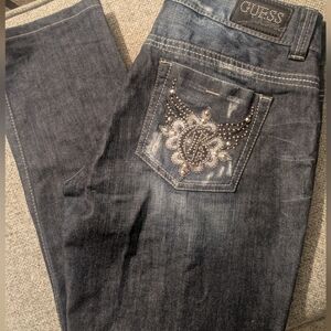 Women's Guest Jeans Dark Color With Rhinestone Designs On The Pockets.